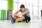 Man-Stretching-important-pre/post-workout