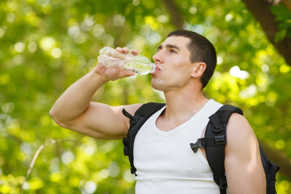man-hydrating-drinking-water-for-preventing-injuries