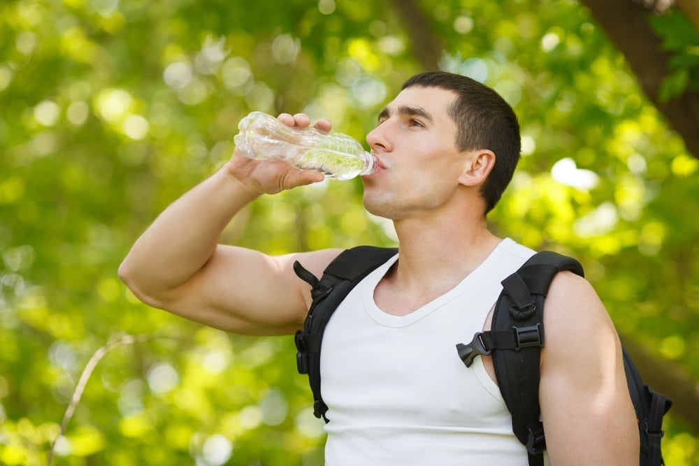 man-hydrating-drinking-water-for-preventing-injuries